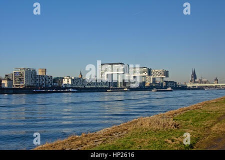 `Crane houses`, Three modern architecture L-shaped apartment building by architect Alfons Linser, and Cologne Cathedral along river Rhine. Stock Photo